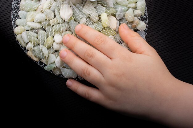 Handful of clean pebbles gravels in hands