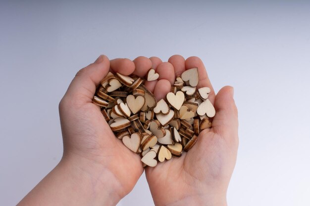 Handful of Retro style wooden hearts on white background