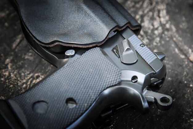 Handgun in holster ready to firing position with safety on