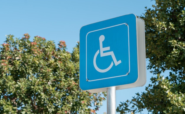 Handicapped icon on the ground of car parking area reserve for disabled people in urban gas station