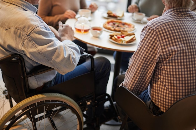 Handicapped man surrounded by friends