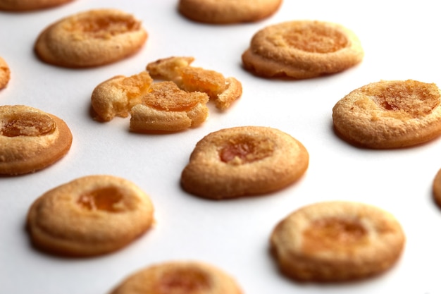 handmade cookies with apricot jam arranged in even rows