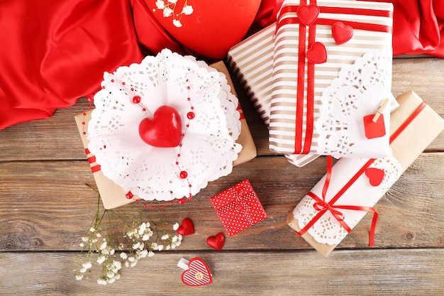 Handmade gifts on Valentine Day, on wooden background