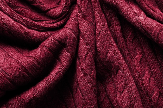 Handmade knitting wool texture background. New 2023 trending PANTONE 18-1750 Viva Magenta colour