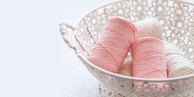 Handmade macrame braiding and cotton threads in basket. Cotton macrame cords and ropes