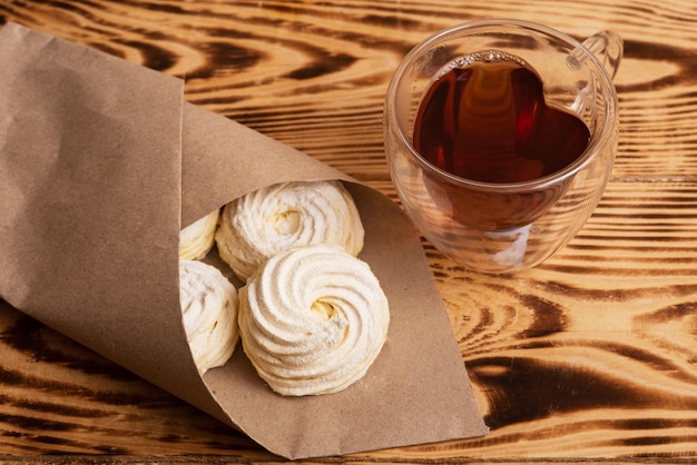 Handmade marshmallow Natural sweetness Apple zephir and cup of tea in wood surface