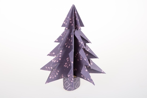 Handmade origami paper craft pine Christmas tree on white