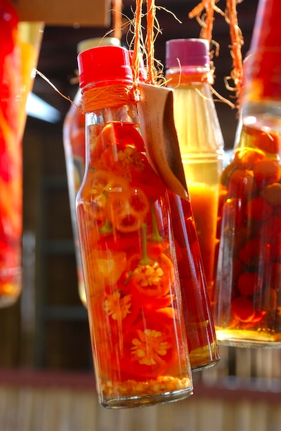 Handmade pepper in glass bottles for sale at a popular fair in Brazil