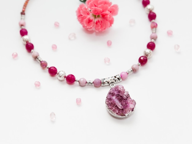 Handmade silver necklace with agate beads and druse plum gemstone agate white background with flower