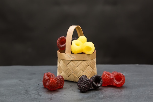 Handmade soap basket in the form of blackberries and raspberries on a black backgroun