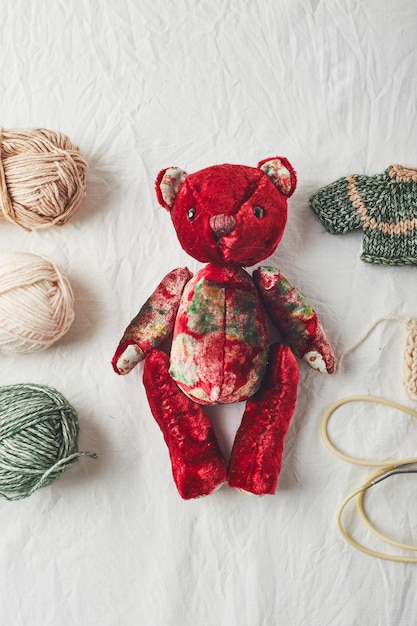 Handmade teddy bear and knitted little sweaters