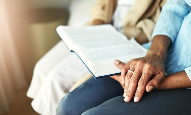 Hands bible and senior couple praying in their home together for scripture faith and trust Family worship and praise with elderly man and woman united in prayer holy or gratitude to Jesus Christ