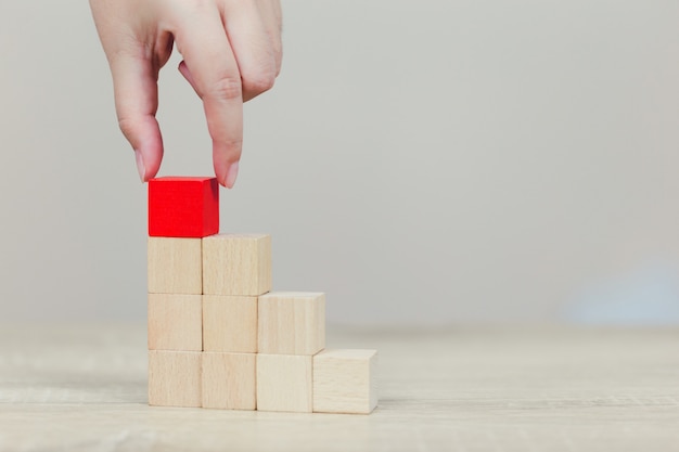 Hands of business,stacking wooden blocks.