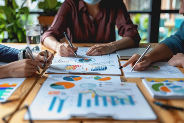 Hands business team having a meeting to analyze data graph charts for a marketing plan