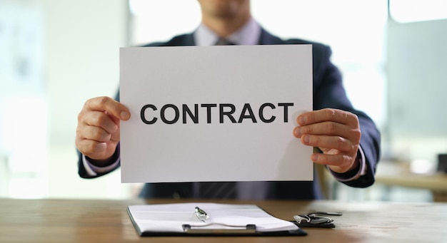 Hands of businessman holding contract document for employment at work in office closeup