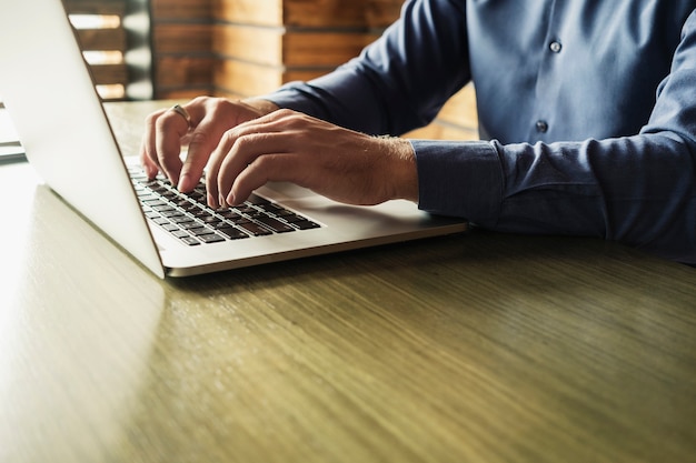 Hands of a businessman typing on a laptop