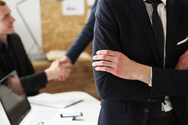 Hands of Businessman  at workplace crossed on chest. White collar worker at workspace shake hands