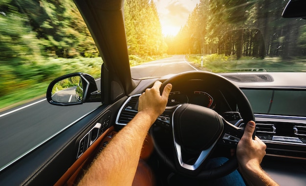 hands of car driver on steering wheel, Driving car at summer day on a country road, having fun driving the empty highway on tour journey - POV, first person view shot