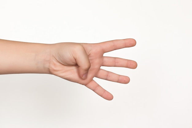 The hands of children's hands show a heart on a white background isolated closeup