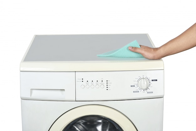 Hands cleaning the washing machine with a washcloth