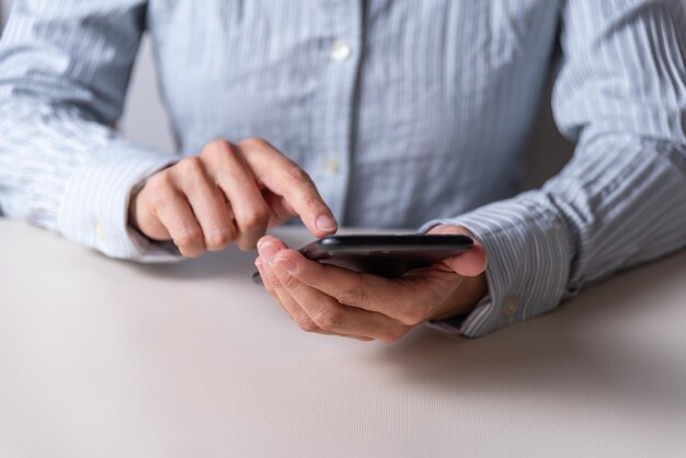 Hands clicking on a mobile phone communication concept telephony networks and communications selective focus