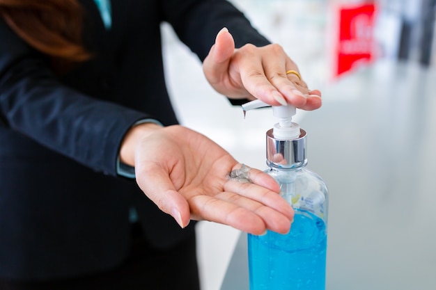 Hands closeup women washing hands with alcohol gel or antibacterial soap sanitizer.