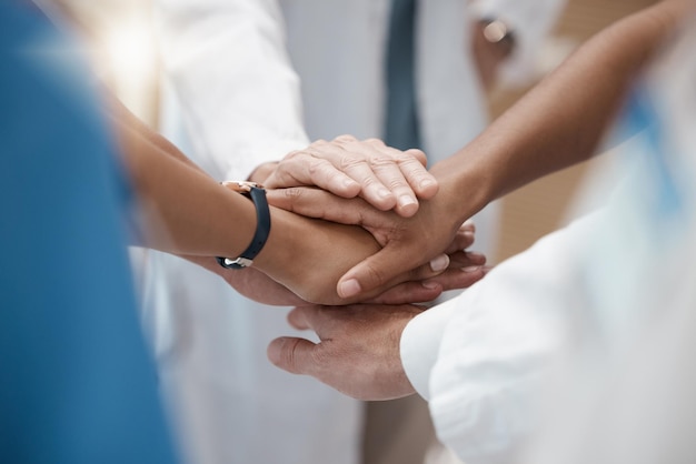 Hands collaboration and healthcare with a medicine team in a huddle or circle in the hospital for insurance or medical Teamwork motivation and solidarity with a doctor and nurse group in a clinic