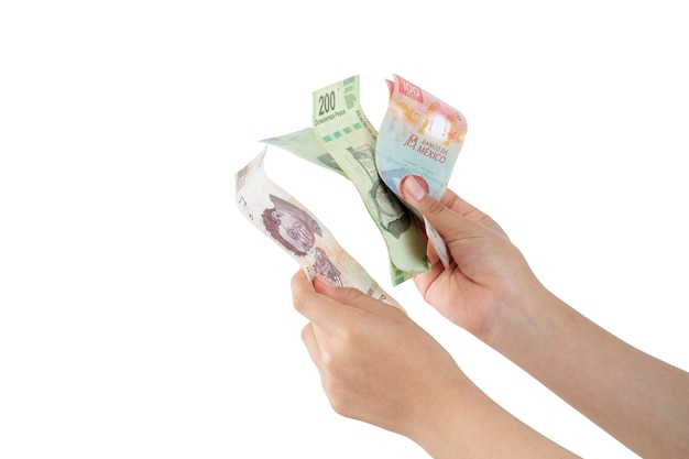 Hands counting Mexican pesos bills of different denominations with white background and copy space