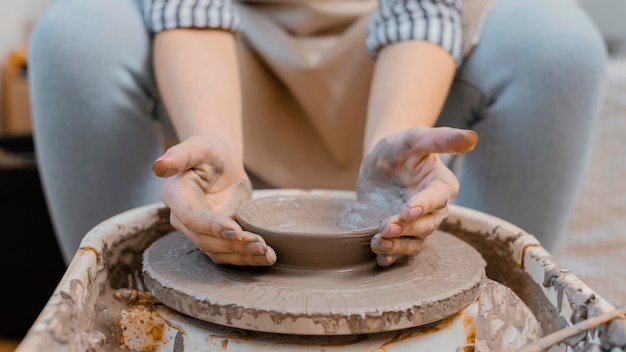 Hands doing pottery close-up