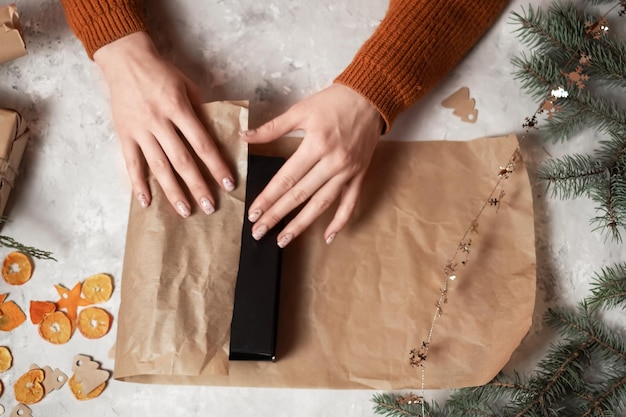 hands of a girl packing gifts for the new year giving gifts new year mood