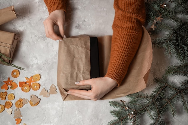 hands of a girl packing gifts for the new year giving gifts new year mood