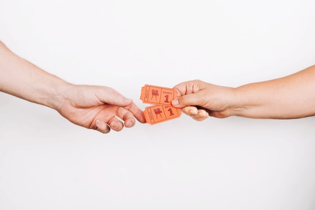 Hands giving tickets to client