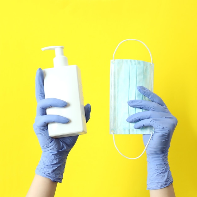 Hands in gloves holds medical tools on yellow