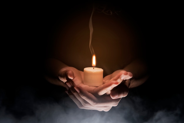 Hands holding candle