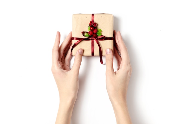 Hands holding Christmas gift box isolated