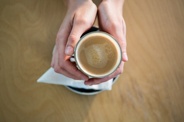 Hands holding a coffee cup