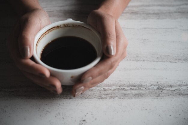 Hands holding a cup of coffee