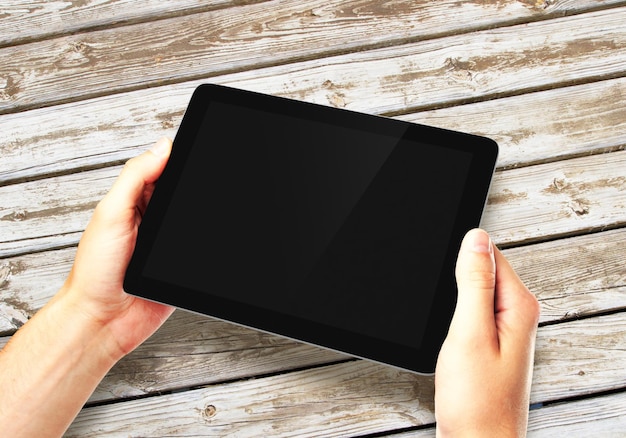 Hands holding digital tablet