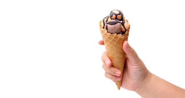 Hands holding fresh waffle cone of ice cream on white background.