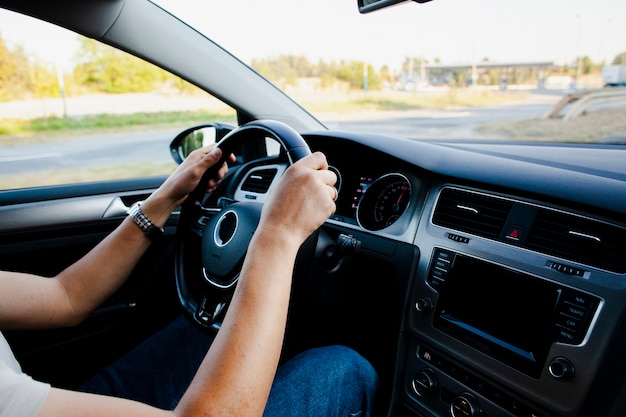 Hands holding modern car wheel