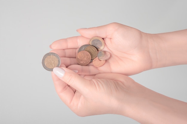 Hands holding money on gray background