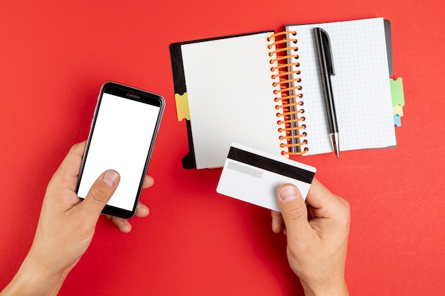 Hands holding a notebook and phone mock up