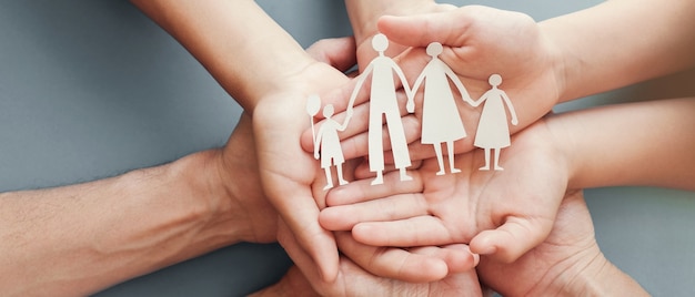 Hands holding paper family