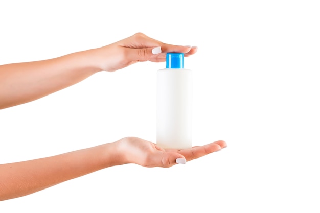 Hands holding plastic bottle isolated