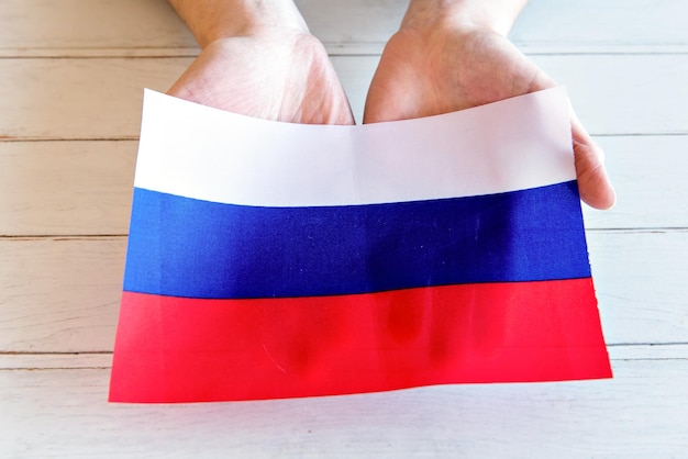 Hands holding Russian flag