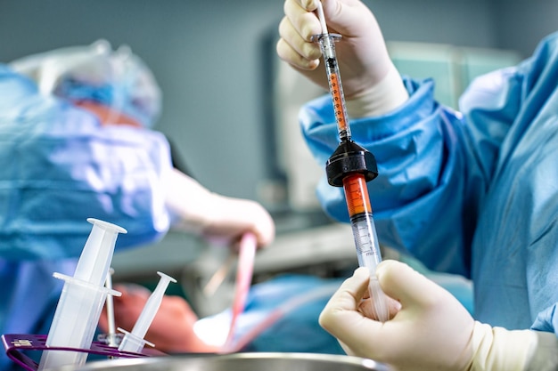 Hands Holding Syringe and Transfer Fat with Nano Fat Transfer Tool in Operation Room