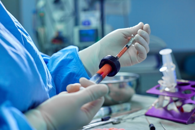 Hands Holding Syringe and Transfer Fat with Nano Fat Transfer Tool in Operation Room