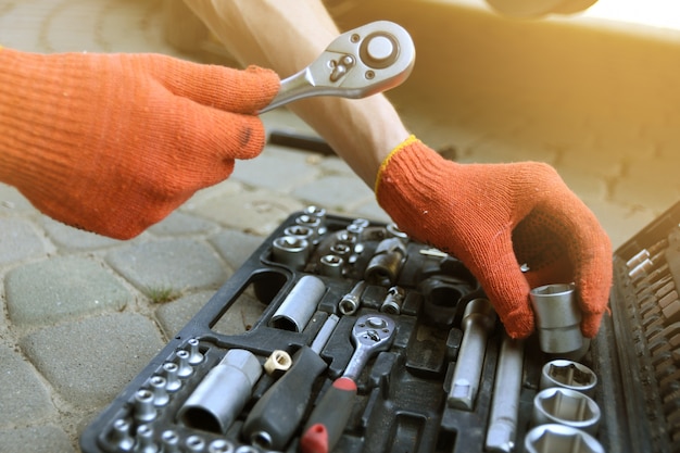 hands holding tools for auto repair service