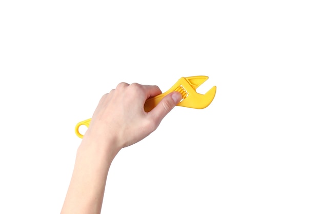 Hands holding toy wrench isolated on white surface