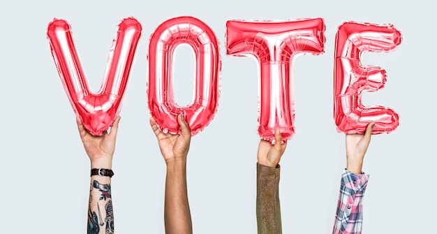 Photo hands holding vote word in balloon letters